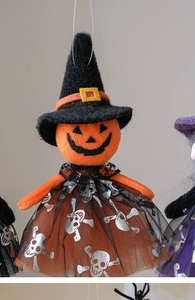 Detail view of Halloween pumpkin ghost hanging ornament with tulle skirt and witch hat