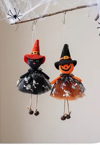 Detail of Halloween witch dolls with pumpkin heads, mesh skirts and jingling metal bells