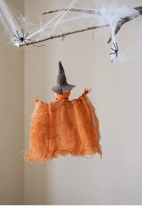 Hanging Halloween pumpkin ghost with burlap cloak and witch hat on decorative spider web