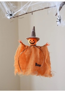 Detail of hanging Halloween pumpkin ghost with orange burlap cloak and Boo text