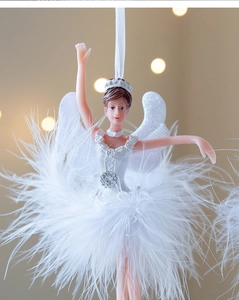 Close-up of ballet girl ornament with white feather skirt and silver flower detail