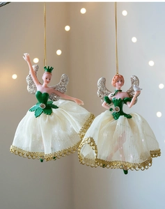Close-up of ballet fairy ornaments with green corsets and white mesh skirts for Christmas