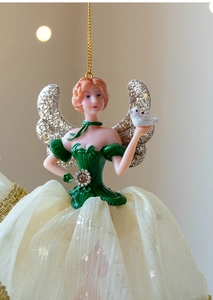 Detailed shot of a ballerina ornament with star sequins and a green bodice for Christmas
