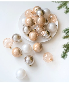 Detail of 6cm champagne gold and silver Christmas ornaments with pine branch accents