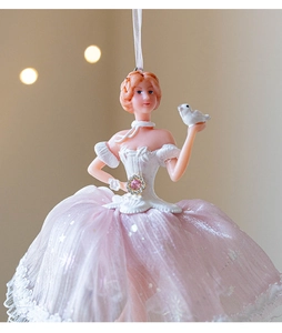 Detail of ballerina ornament with pink tulle skirt and bird on a festive background