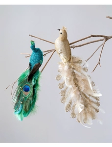 Exquisite glittery peacock ornaments with feather tails hanging on rustic branches