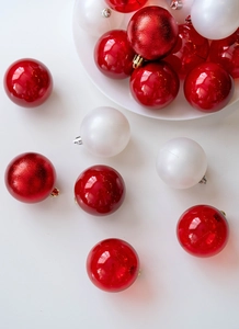 Close-up of 6cm Christmas balls with shiny, matte, and pearlescent red and white textures