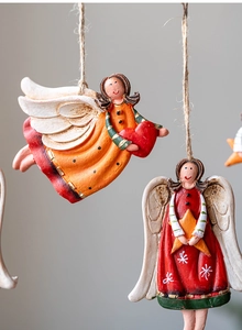 Close-up of vintage resin Christmas angel ornaments with aged wood texture and jute ropes