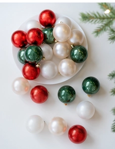Detailed view of red, green, and white 6cm Christmas balls with mixed textures on a tray
