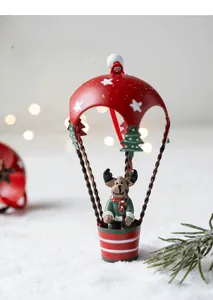 Detailed view of a Christmas reindeer figurine in a red and white hot air balloon basket