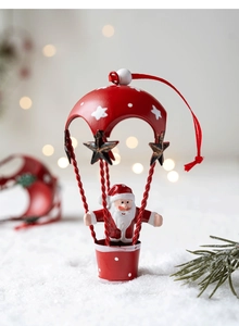 Detail of red Christmas hot air balloon ornament featuring Santa Claus in a festive scene