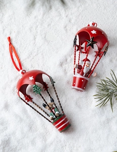 Detail of metal Christmas ornaments with Santa and reindeer figures on white snowy background