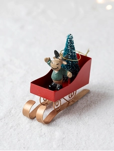 Close-up of metal Christmas sleigh with elk figurine and mini tree festive decoration