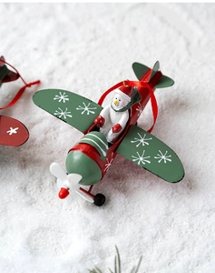 Detail of a vintage iron red airplane Christmas ornament with a cute snowman pilot inside