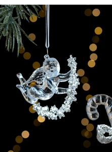 Macro shot of a transparent acrylic angel ornament with silver glitter star for Christmas