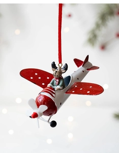 Detail of vintage metal airplane ornament with a reindeer pilot for Christmas tree decor