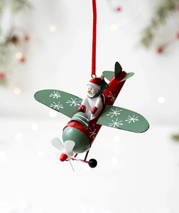 Detail of red metal plane ornament with snowman pilot and green snowflake wings
