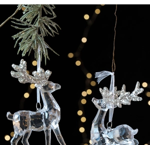 Detail of crystal acrylic reindeer ornaments with silver glitter antlers and white ribbons