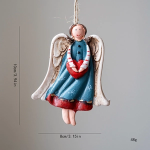 Vintage Christmas angel ornament in blue dress holding red heart on gray background