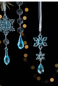 Close-up of sky blue Christmas icicle ornaments with snowflakes on a festive bokeh background