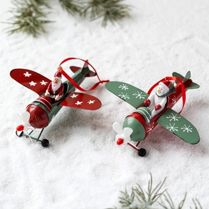 Vintage iron airplane Christmas tree ornaments with Santa and Snowman figures on snow
