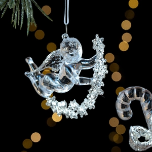 Elegant transparent acrylic Christmas angel ornament with silver sequins on dark background