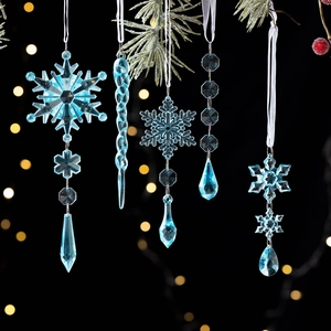 5pcs light blue clear acrylic snowflake and icicle ornaments hanging on a snowy tree