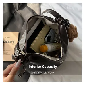 Top view of large capacity brown leather bag showing spacious interior with teddy charm