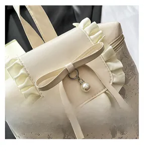 Detail of ruffled lace backpack with large bow, pearl pendant and floral pattern