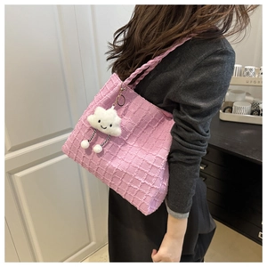 Close-up of pink tote bag with textured waffle fabric and a cute white cloud pendant