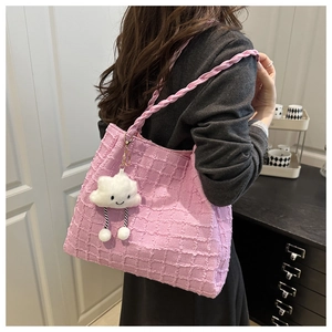 Detailed texture of pink checkered tote bag with woven strap and cute cloud charm