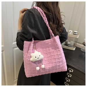 Detail of pink bubble texture tote bag with woven handles and cute cloud charm accessory