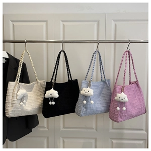 Detail of woven texture tote bags in four colors with cloud plush pendants