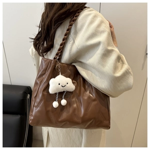 Brown large hobo bag with braided strap and cloud charm detail shown on model