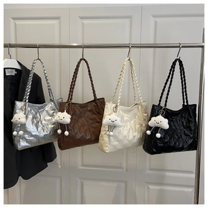 Close-up of quilted tote bags featuring embossed teddy bears and cloud charms