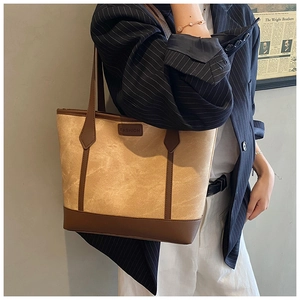 Detail of vintage contrast tote bag with FASHION label and deep brown leather straps