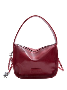 Burgundy glossy leather handbag with wide handle and metal chain strap for women