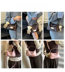 Model wearing stylish small faux leather crossbody bags in pink and brown with bear charms