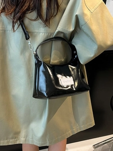Glossy black patent leather underarm bag with silver hardware and shoulder strap for women