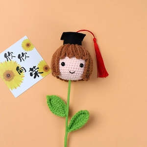 Handmade crochet graduation flower gift featuring a doll head with black mortarboard hat