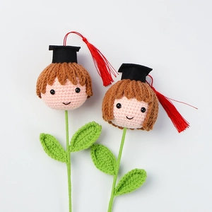 Detail of handmade crochet graduation dolls with academic caps on flower stems