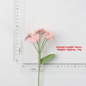 Detail of hand-crocheted pink flower with pearl core and green stem, 46cm length measurement