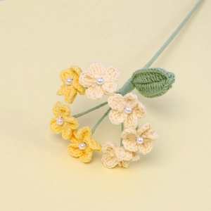 Handmade crochet forget-me-not flower bouquet with pearl accents and green leaves