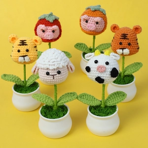 Set of six handmade crochet animal potted plants including tigers sheep and cows