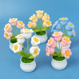 Macro detail of handmade crochet lily of the valley potted flowers in five vibrant colors