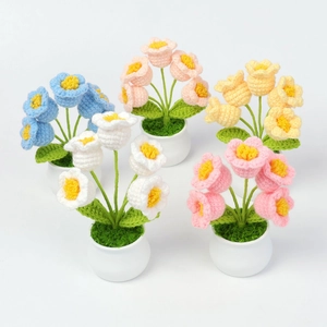Top-down view of five colorful handmade crochet tulip potted plants for home decor