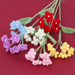 Detailed view of handmade crochet flowers with colorful petals and pearl centers