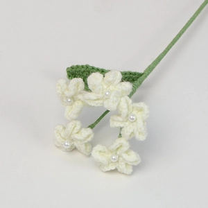 Handmade crochet forget-me-not bouquet with white flowers, green leaves and pearl accents