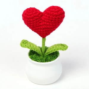 Handmade crochet red heart bouquet in a white ceramic pot for home office decoration
