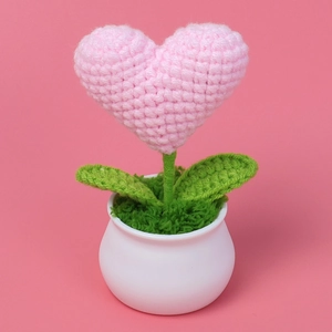 Handmade crochet heart potted plant in pink yarn with white pot for desktop decoration